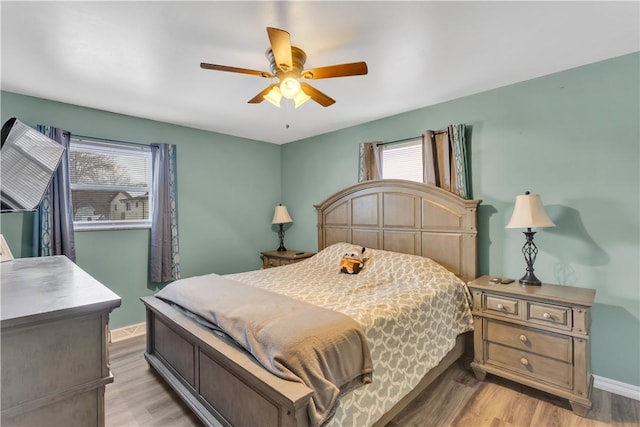 bedroom with ceiling fan and light hardwood / wood-style floors