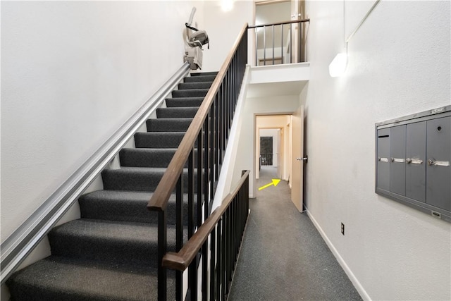 stairway featuring a high ceiling