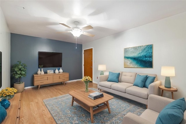 living room with ceiling fan and hardwood / wood-style floors