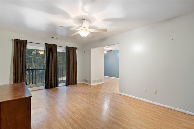 spare room featuring light hardwood / wood-style floors and ceiling fan