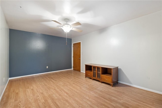 spare room featuring ceiling fan and light hardwood / wood-style flooring