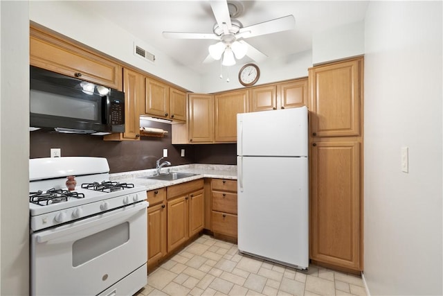 kitchen featuring ceiling fan, white appliances, and sink