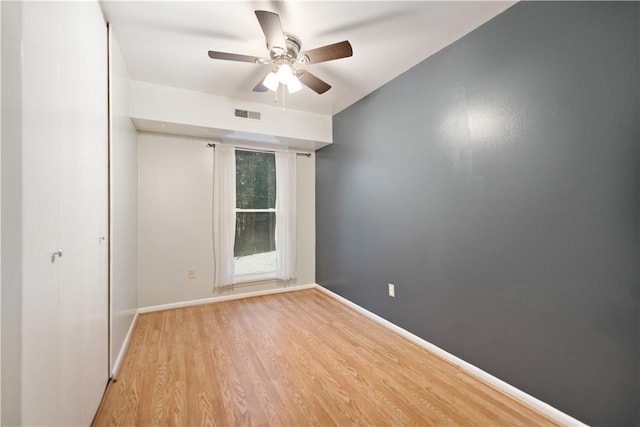 empty room featuring ceiling fan and light hardwood / wood-style flooring