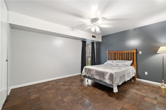 bedroom with dark parquet flooring and ceiling fan