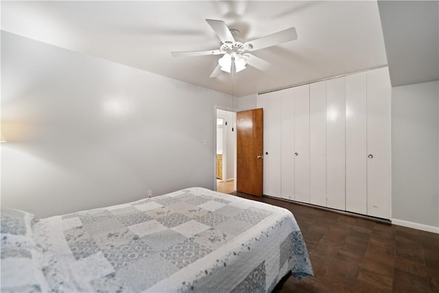 bedroom featuring ceiling fan and a closet