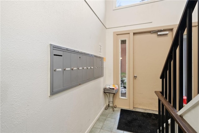 entrance foyer with mail boxes and light tile patterned floors