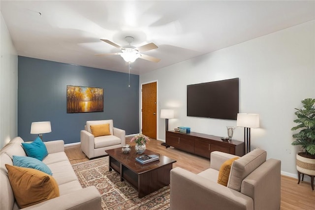 living room with hardwood / wood-style flooring and ceiling fan