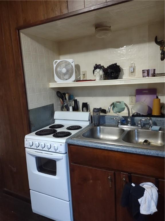 kitchen featuring electric stove and sink