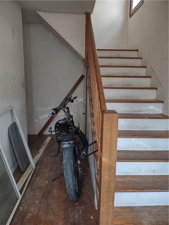 stairs featuring hardwood / wood-style floors