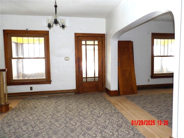 entryway with a chandelier and hardwood / wood-style floors