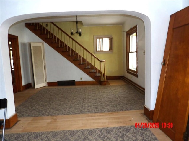 foyer entrance featuring an inviting chandelier and light hardwood / wood-style floors