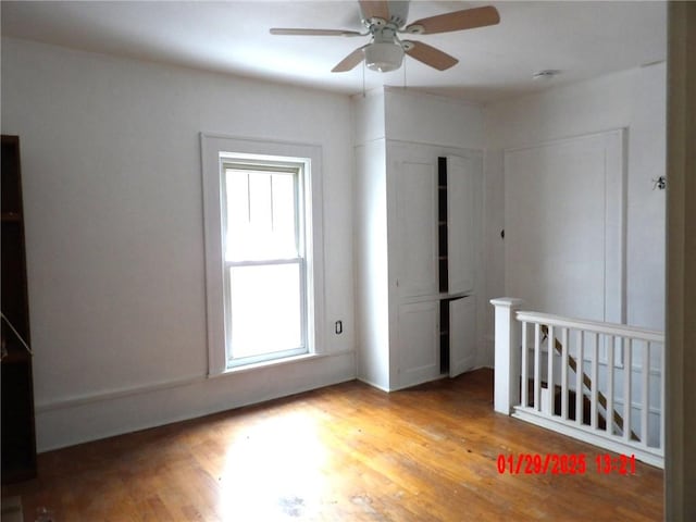 empty room featuring ceiling fan and light wood-type flooring