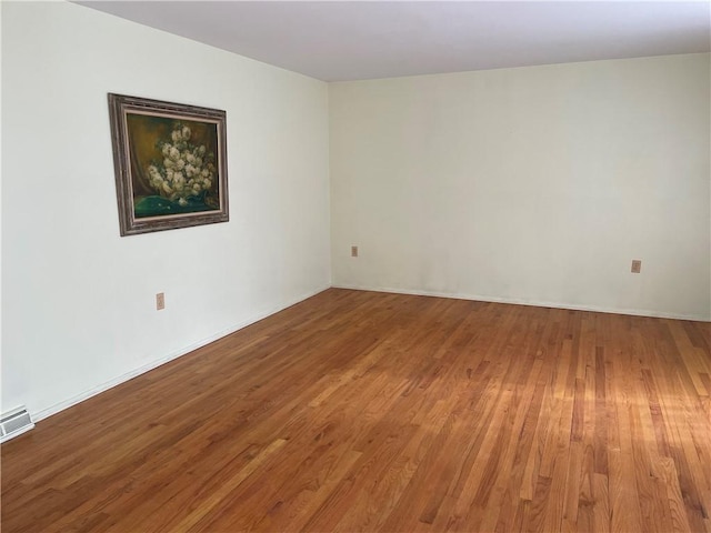 spare room featuring hardwood / wood-style floors