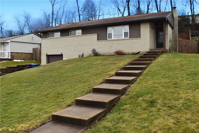 view of front of house with a garage and a front lawn