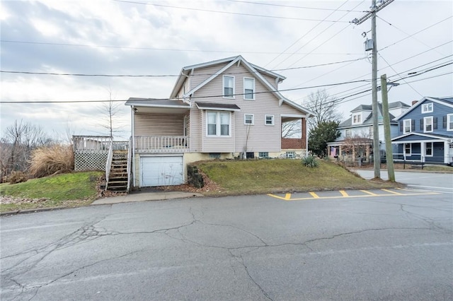 view of front of home featuring a garage and a front lawn