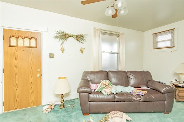 living room with ceiling fan and carpet