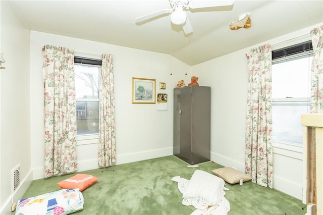 interior space featuring ceiling fan, lofted ceiling, and carpet