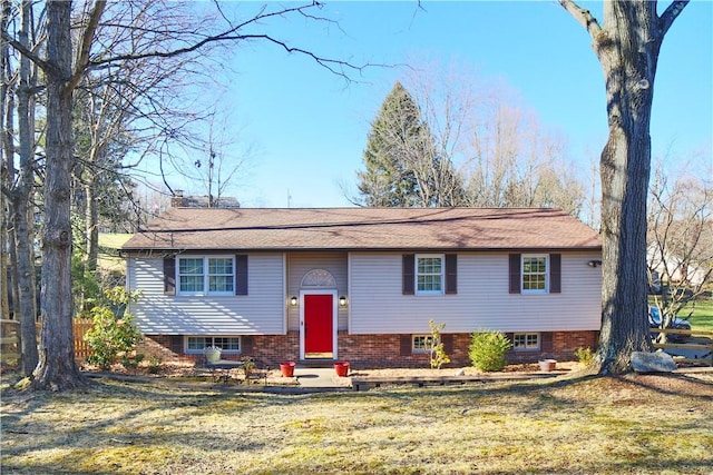 bi-level home with a front lawn and a chimney