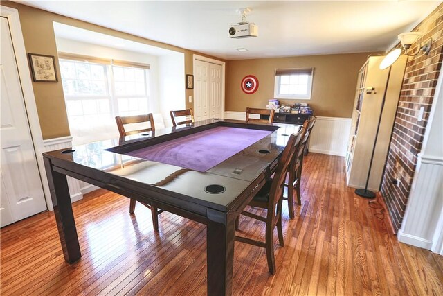 dining room with hardwood / wood-style floors and wainscoting