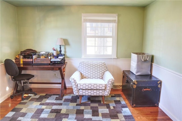 office space featuring a wainscoted wall and wood finished floors