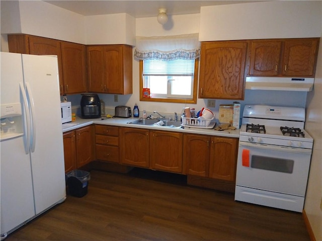 kitchen featuring dark hardwood / wood-style flooring, sink, and white appliances