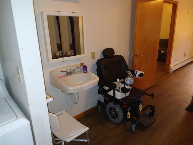 bathroom featuring sink, hardwood / wood-style floors, and baseboard heating