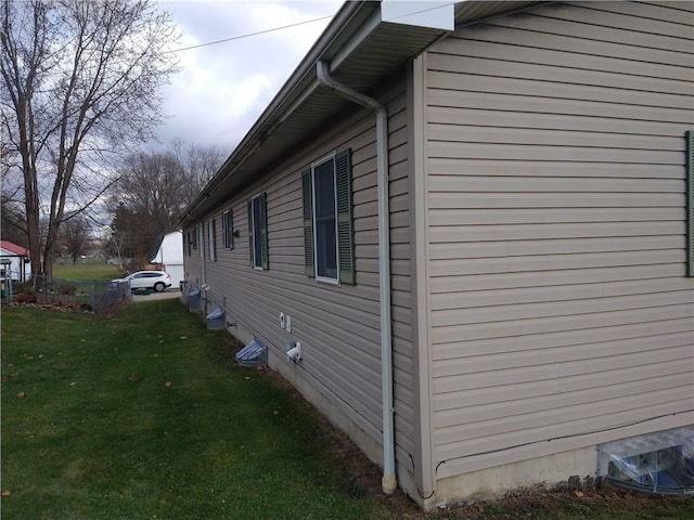 view of side of home with a yard