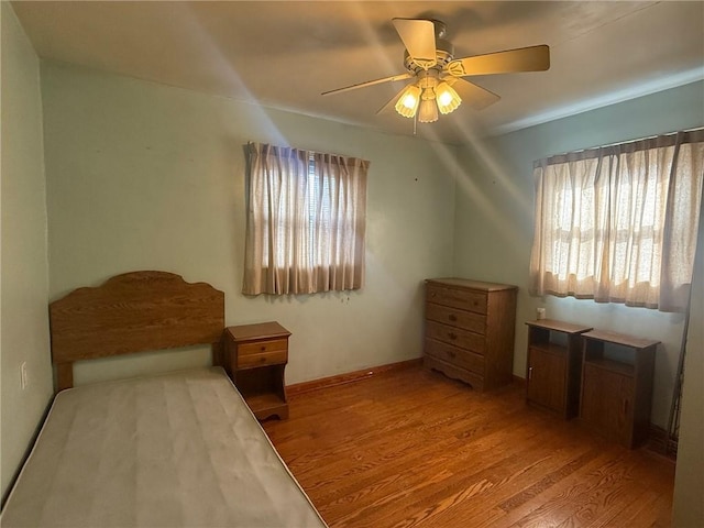 bedroom with ceiling fan and light wood-type flooring