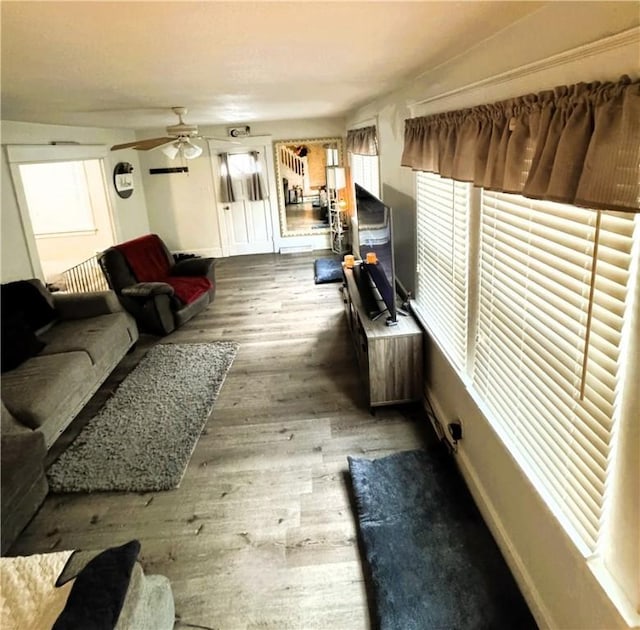 living room featuring dark hardwood / wood-style flooring and ceiling fan