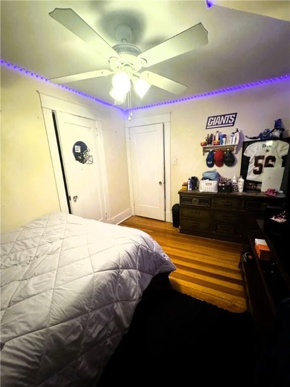 bedroom with light hardwood / wood-style flooring and ceiling fan