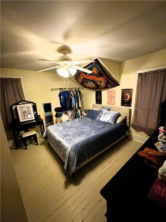 bedroom with light hardwood / wood-style flooring and ceiling fan