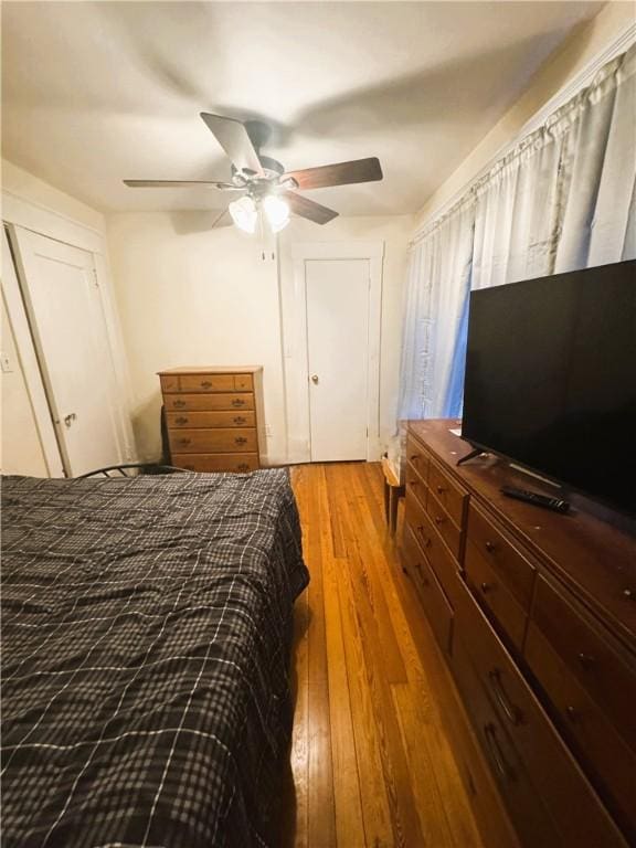 bedroom with hardwood / wood-style flooring and ceiling fan