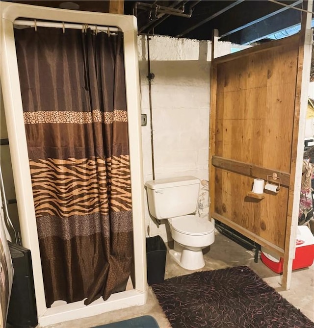 bathroom featuring concrete floors and toilet