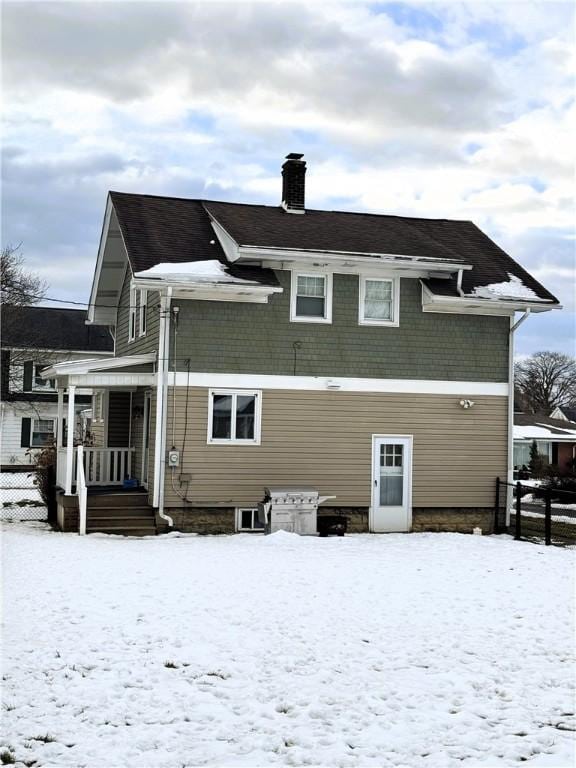 snow covered house with a porch