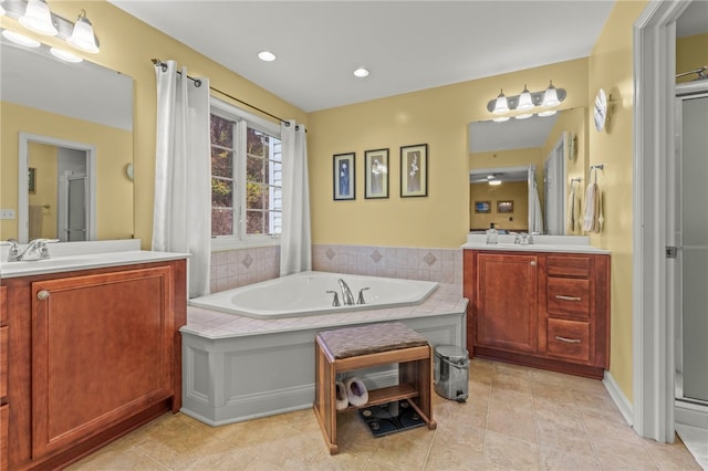 bathroom with tile patterned floors, vanity, and separate shower and tub