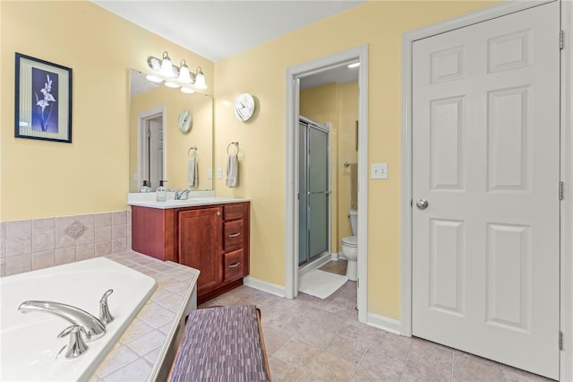 full bathroom featuring shower with separate bathtub, vanity, tile patterned floors, and toilet