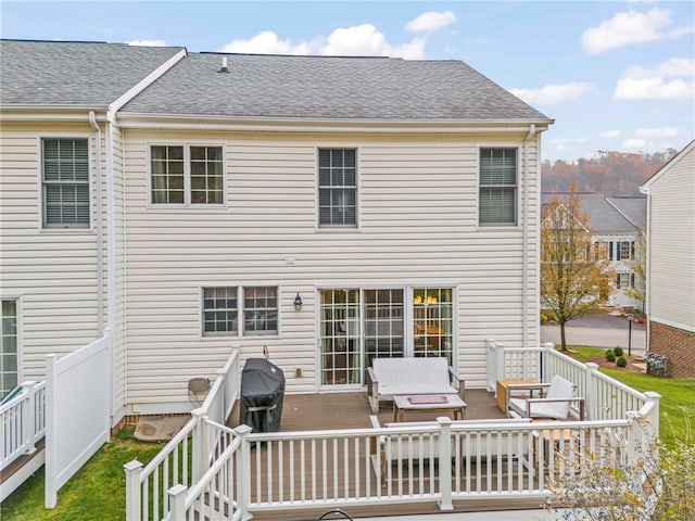 back of house with outdoor lounge area and a deck