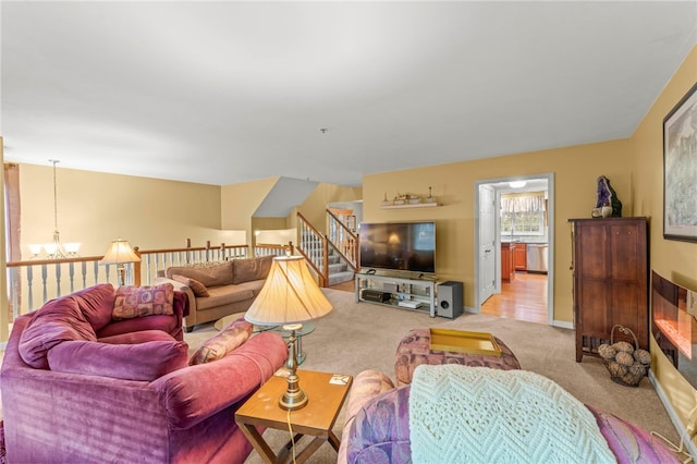 living room with light carpet and an inviting chandelier