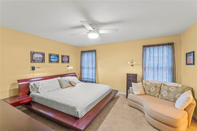 bedroom featuring multiple windows, carpet floors, and ceiling fan