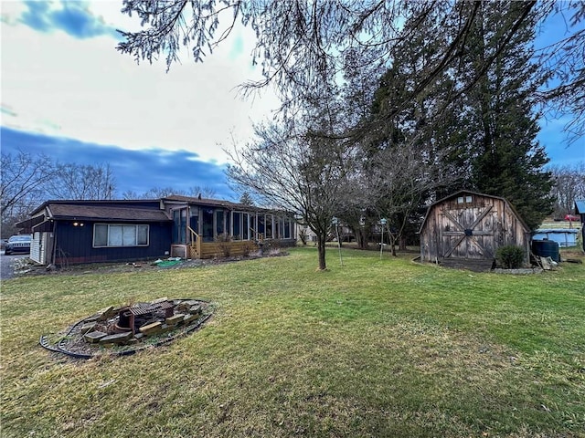 view of yard with an outdoor fire pit and a storage unit