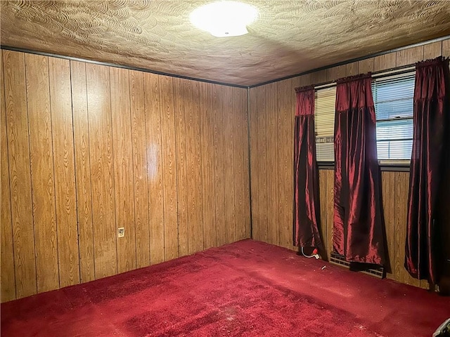 unfurnished room featuring carpet floors and wooden walls