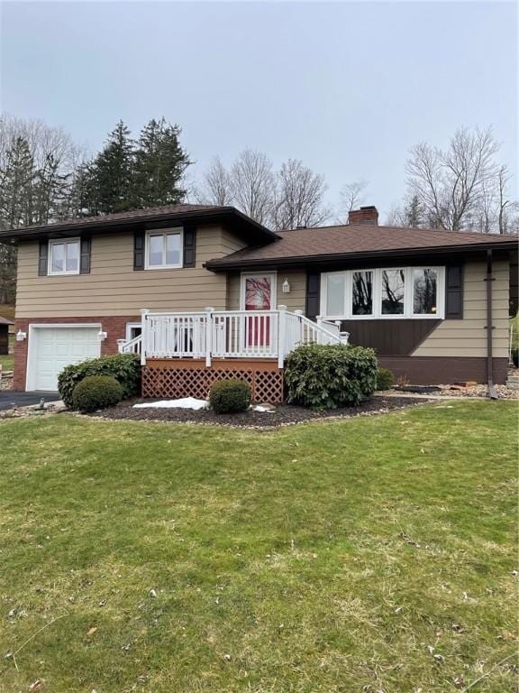 view of front of home with a wooden deck, a garage, and a front yard