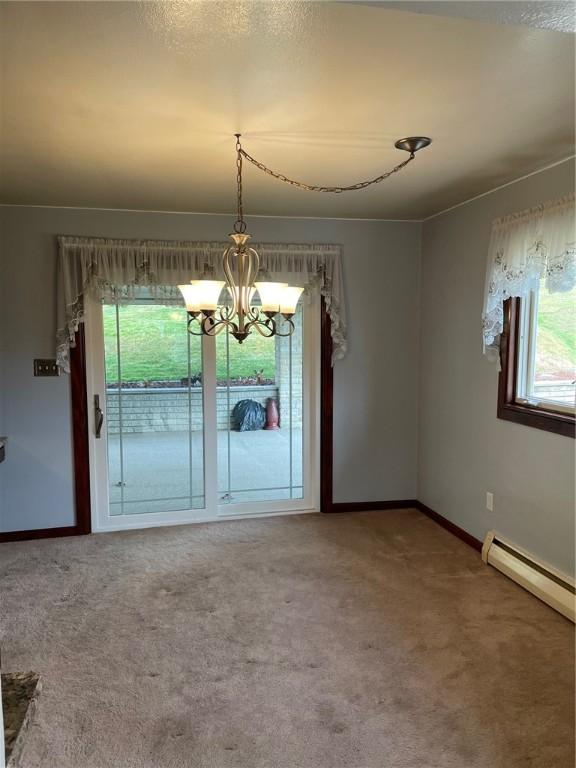 interior space featuring a notable chandelier and a baseboard heating unit