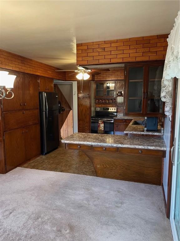 kitchen with black fridge, light colored carpet, stainless steel electric stove, and ceiling fan