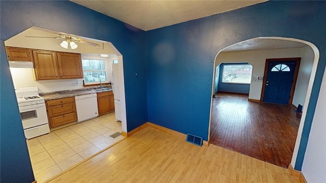 kitchen featuring a healthy amount of sunlight, white appliances, ceiling fan, and light wood-type flooring