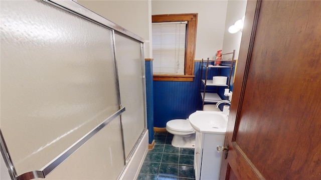 full bathroom featuring enclosed tub / shower combo, vanity, tile patterned floors, and toilet