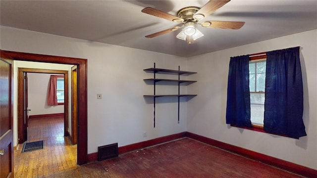 unfurnished room featuring ceiling fan and dark hardwood / wood-style flooring