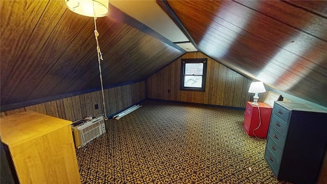 additional living space with vaulted ceiling, wood ceiling, and wood walls