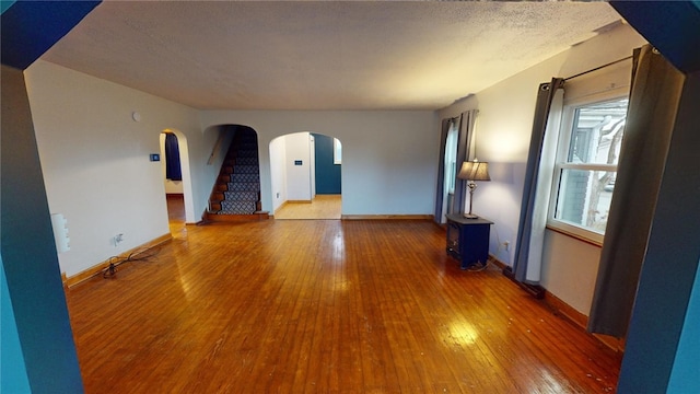 spare room featuring hardwood / wood-style flooring and a textured ceiling