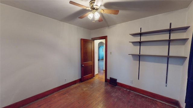 unfurnished room featuring ceiling fan and dark hardwood / wood-style flooring